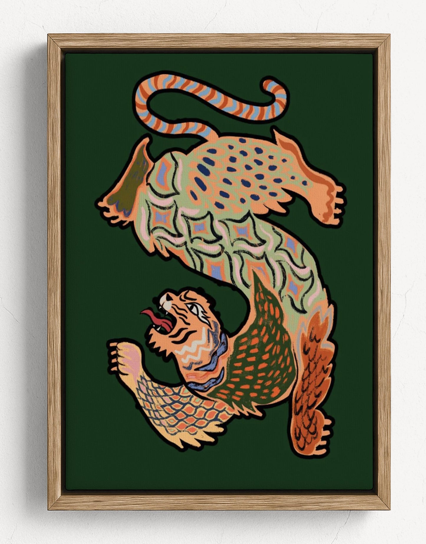 Framed wall art featuring a stylized, patterned animal illustration in warm tones on a dark green background, shown in a light wood frame against a white wall. Asian Tiger Green – Framed Poster Detail