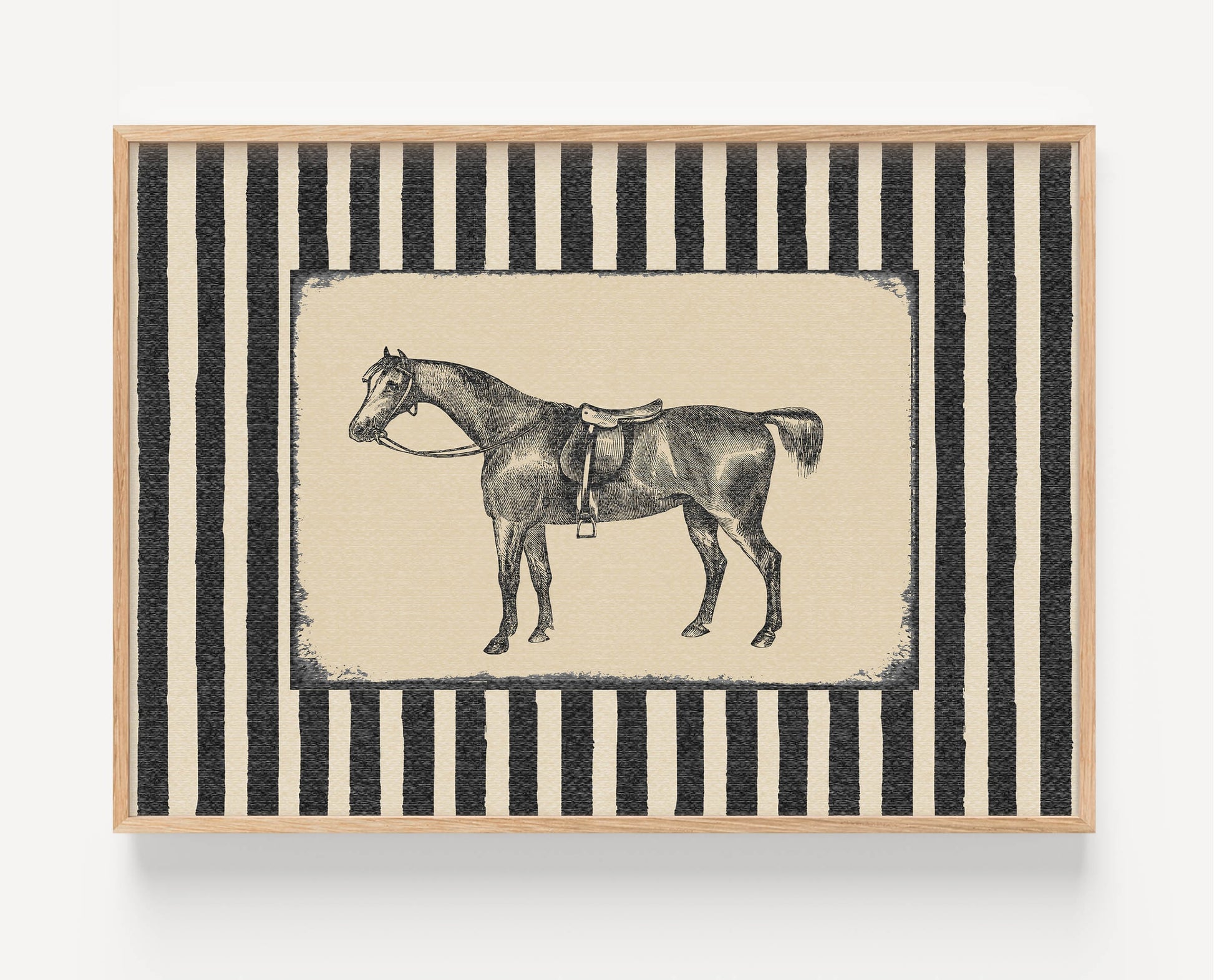 A framed art print featuring a black and white illustration of a saddled horse, set against a background of vertical black and cream stripes, enclosed in a light wood frame.
