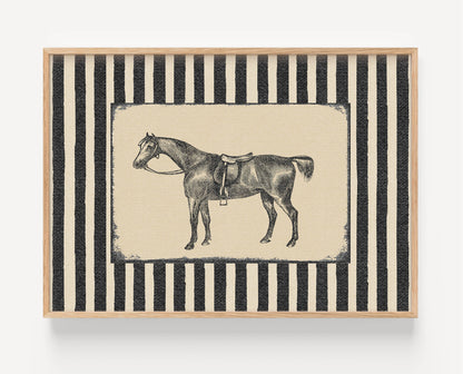 A framed art print featuring a black and white illustration of a saddled horse, set against a background of vertical black and cream stripes, enclosed in a light wood frame.