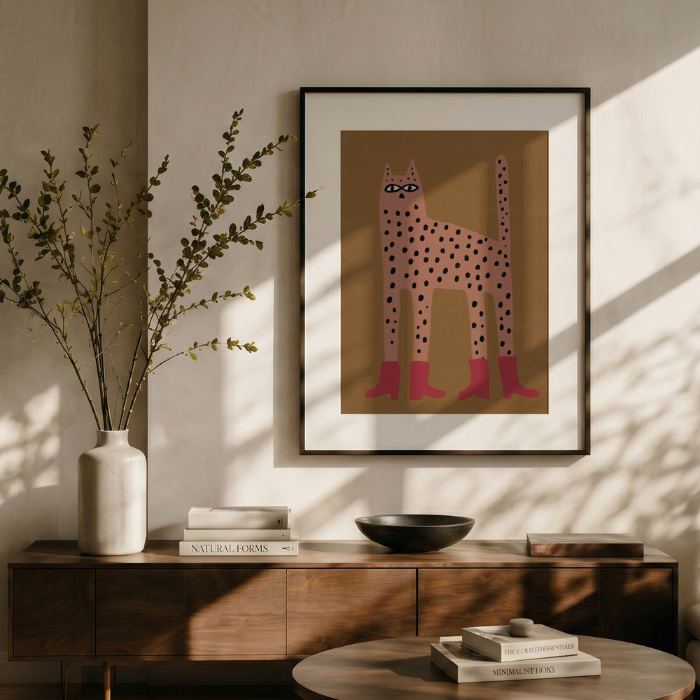 Framed artwork of a stylized cat on a wall above a wooden console table with decor items.