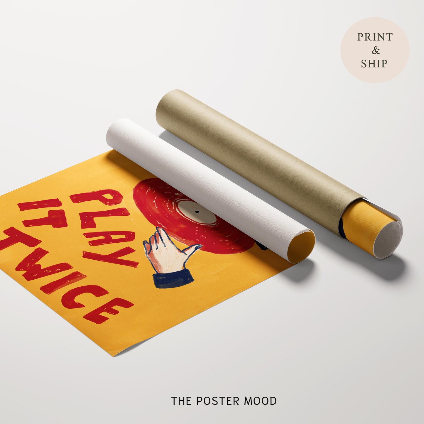 A rolled poster mockup on a light gray background, showing a partially unrolled yellow poster with red text reading 'PLAY TWICE' and a red vinyl record illustration. A second rolled section lies beside it in white and gold.