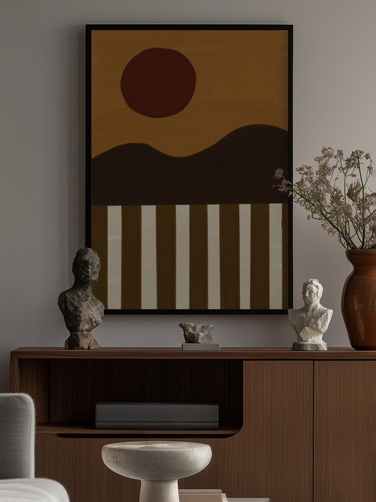 Abstract art piece with a sun and striped pattern on a wall above a wooden console table.