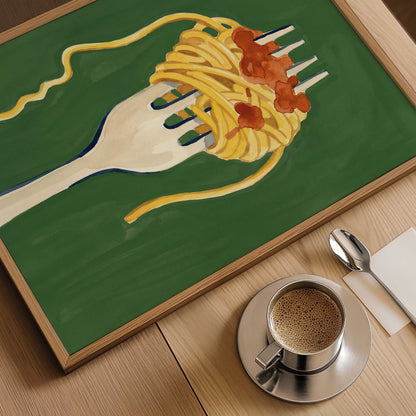 A framed art print depicting a white fork twirling spaghetti with red tomato sauce on a green background, styled on a wooden table next to a cup of coffee, a spoon, and a napkin.