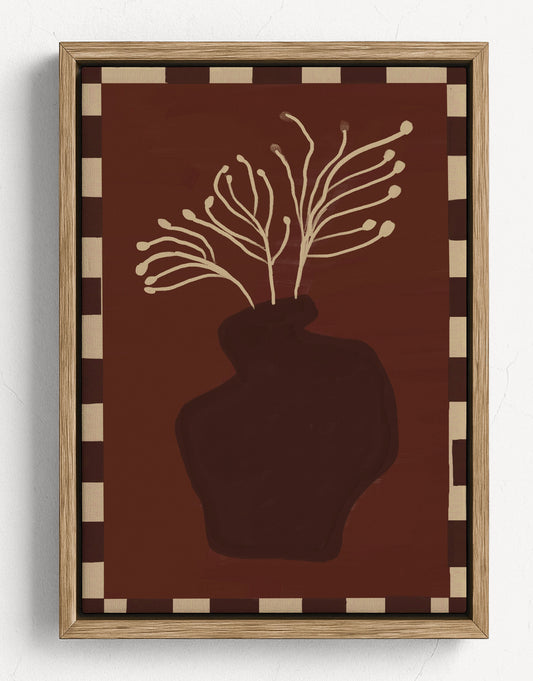 Decorative wall art with a vase and branches on a brown background, framed in wood.