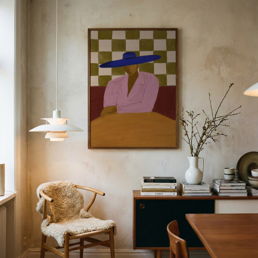 Room interior with a painting of a person wearing a blue hat, a chair with a fur cover, and a table with books.