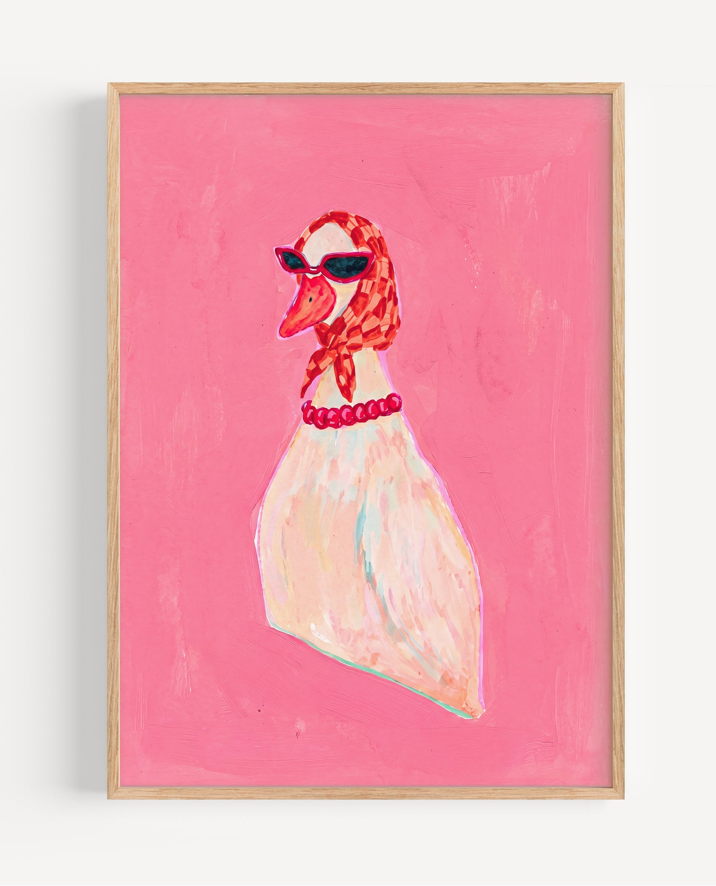 Framed artwork of a swan wearing sunglasses and a red necklace on a pink background
