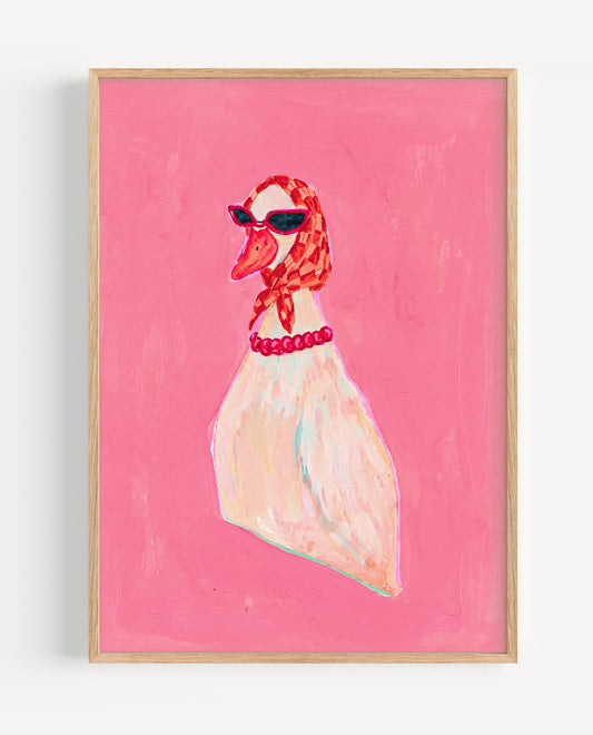 Framed artwork of a swan wearing sunglasses and a red necklace on a pink background
