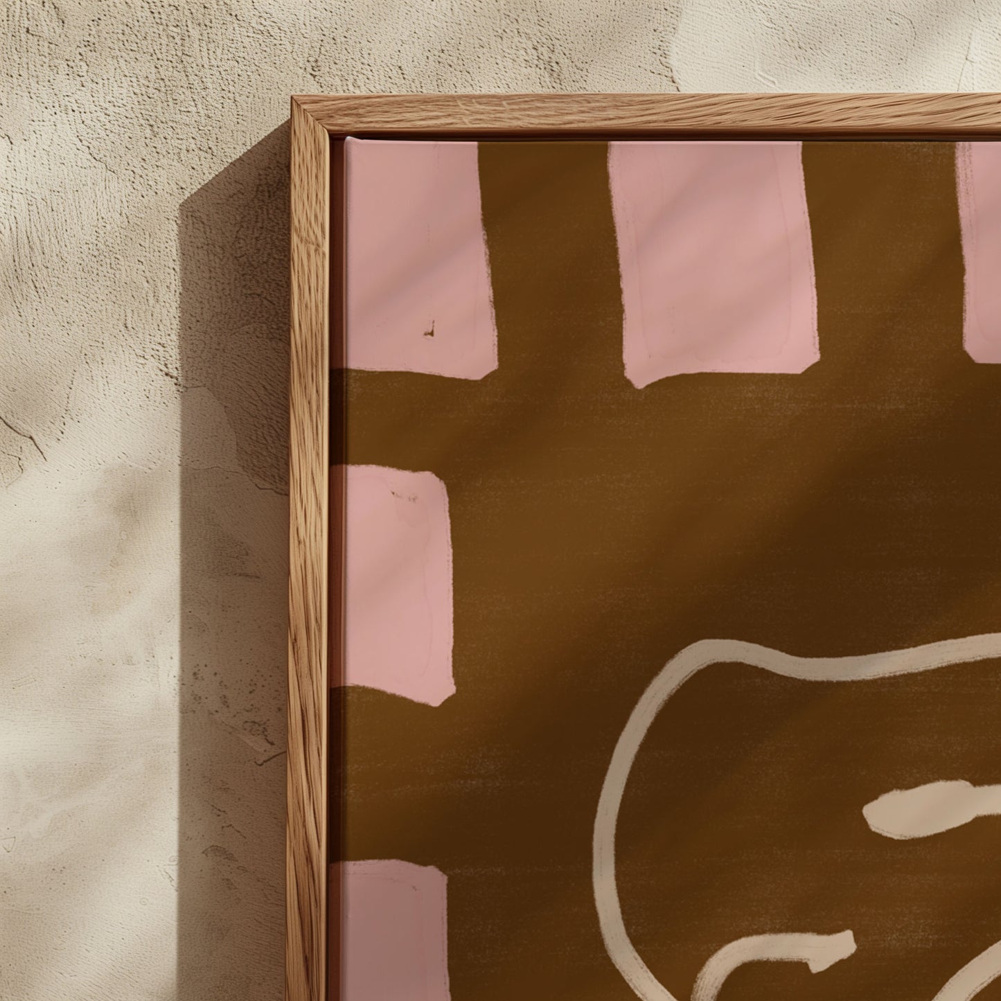 Framed abstract artwork with pink and brown colors on a textured wall.