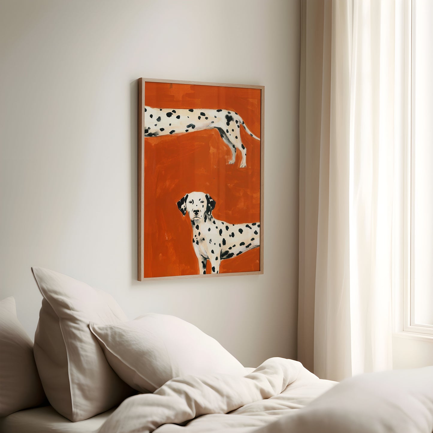 Framed artwork of two Dalmatians on an orange background above a bed.