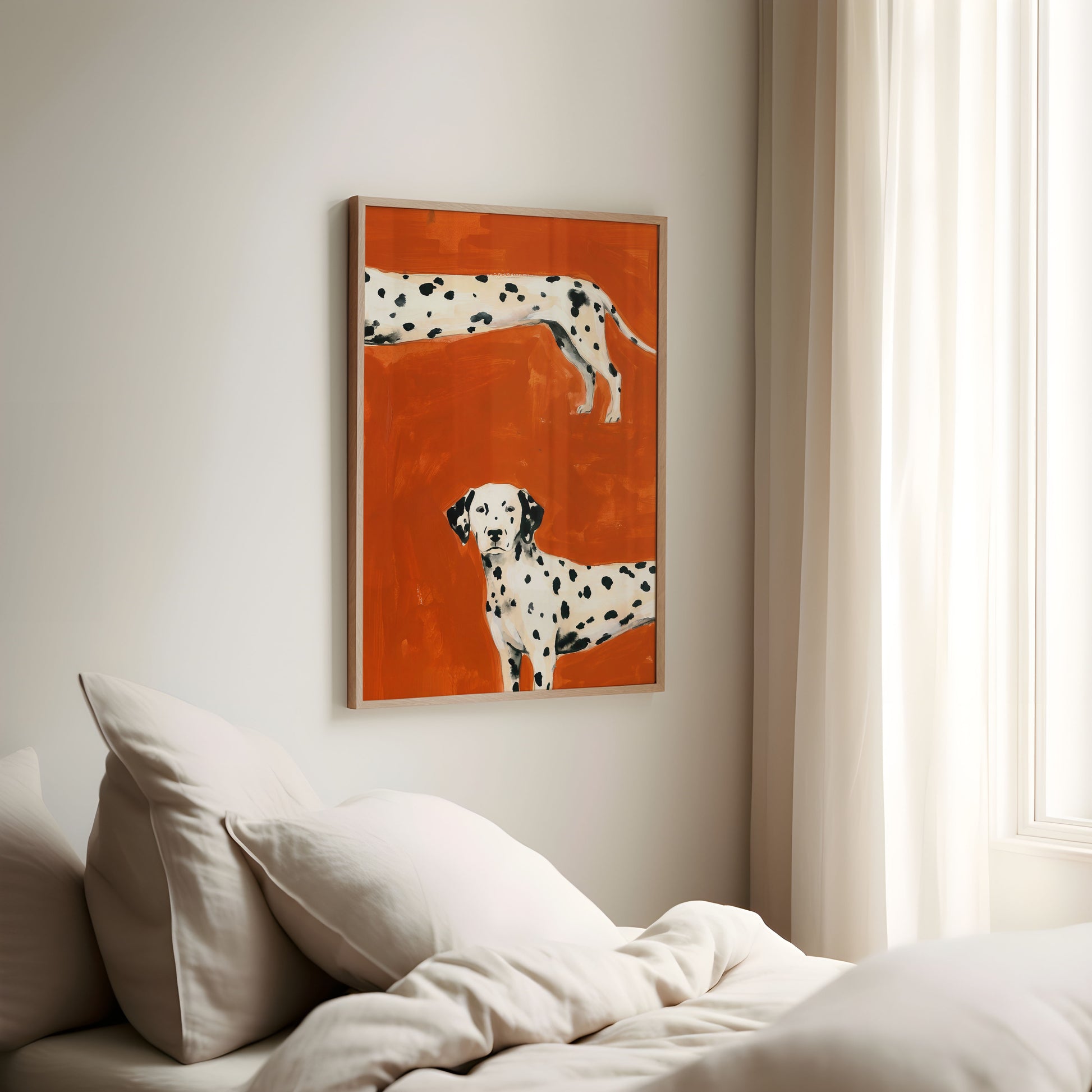 Framed artwork of two Dalmatians on an orange background above a bed.