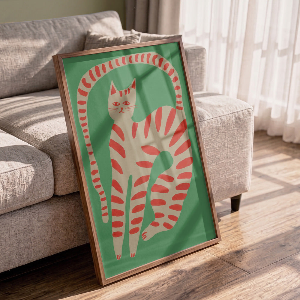 Framed artwork of a red and white striped cat on a green background in a living room.